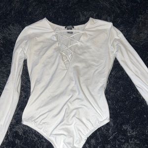 White Bodysuit. Long sleeves. Open Cleavage.